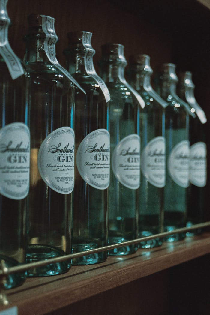 A row of bottles of gin on a shelf